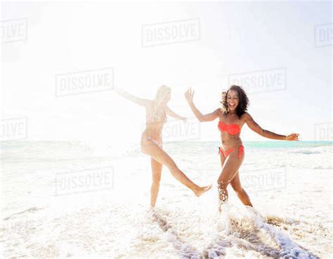 Female Friends On Beach Stock Photo Dissolve