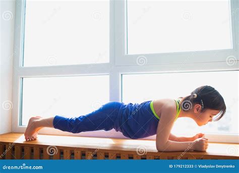 Little Girl Doing A Plank Exercise Workout At Home Cute Kid Is