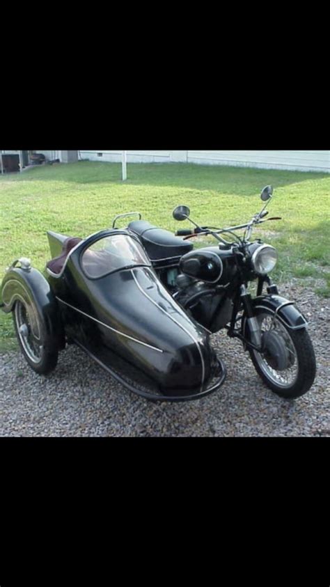 An Old Motorcycle With A Side Car Attached To It