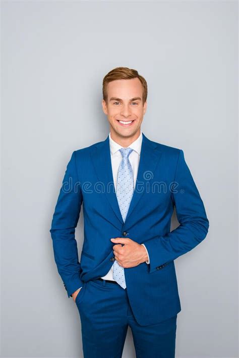 Portrait Of Handsome Young Businessman Buttoning His Jacket Stock Image