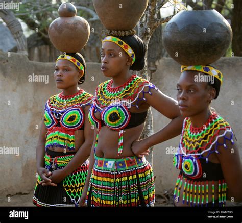 Zulu Girls Wearing Traditional Beaded Dress And Carrying Pots On Their