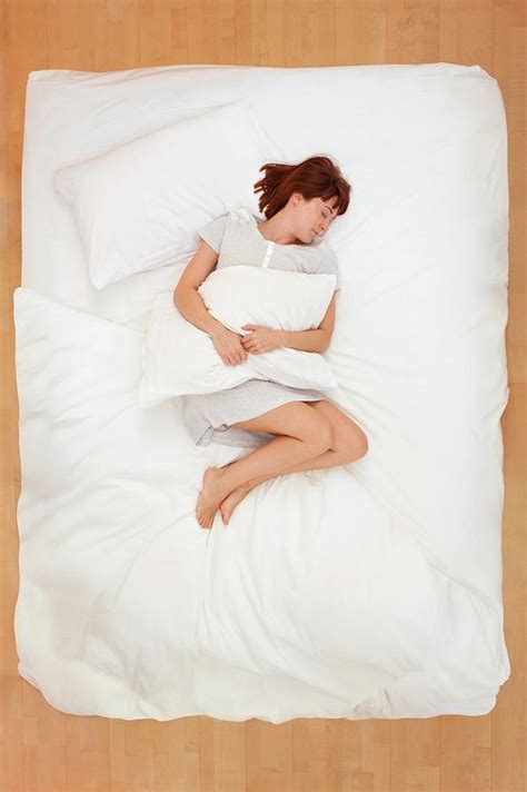 Woman Lying In Bed Holding Pillow Photograph By Ian Hootonscience