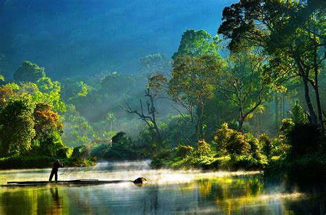 Landscape is more than flat land covered by floodwater, the seeping of peat bogs, a river of liquid pewter viewed from a. morning bliss situ gunung lake indonesia