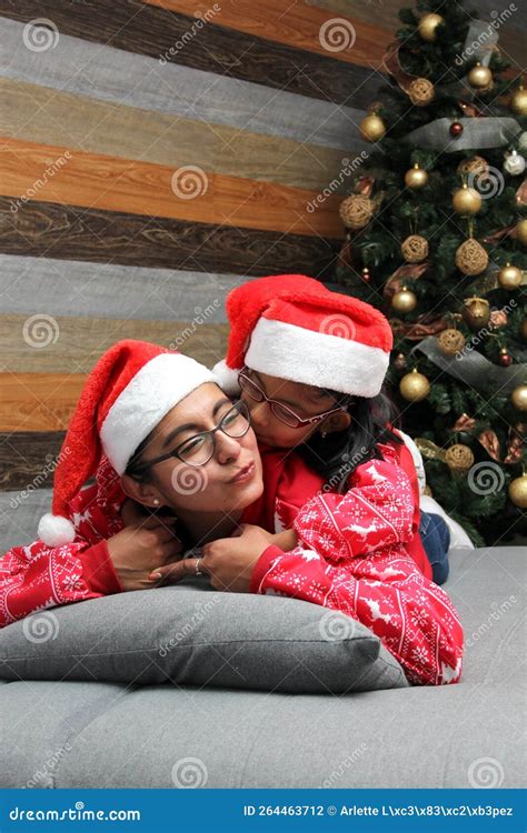 single divorced mom and daughter latina brunettes with glasses dressed in pajamas play in bed