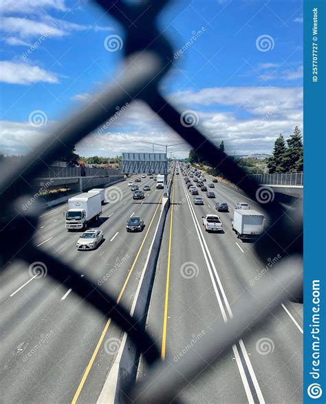 Vertical View Down The Freeway Hwy 880 Through A Chain Link Fence