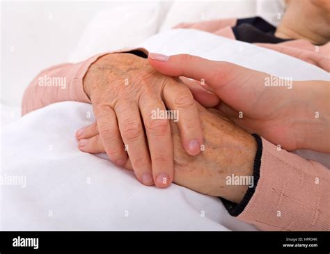 Caregiver Holding Elderly Patients Hand At Home Stock Photo Alamy