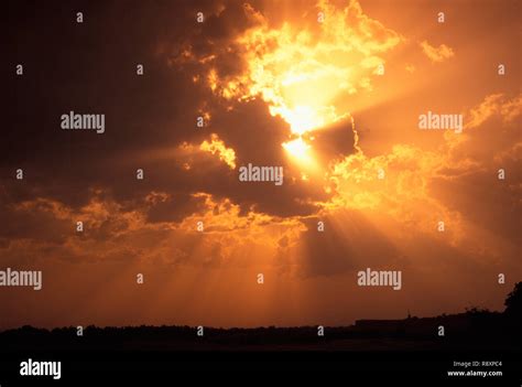 Sunrays Peeping Through Clouds Stock Photo Alamy