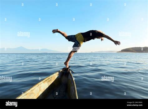 Man Jumping From Boat Into Sea Stock Photo Alamy
