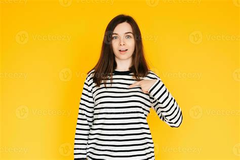 Delighted Woman Pointing at Herself in Amazement - Humorous Reaction