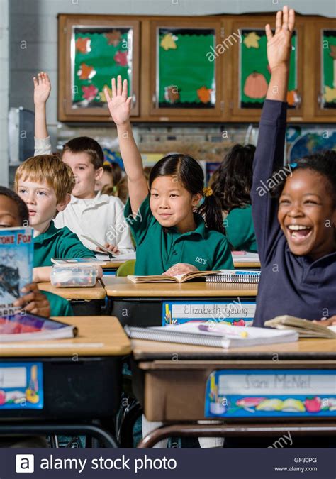 Download This Stock Image Children Raising Hands In Private Elementary