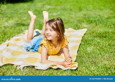 Child Lying On The Blanket On The Grass In The Sun Day Little Girl