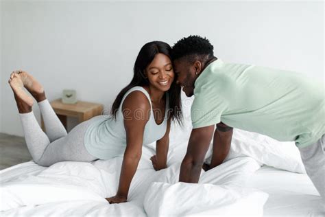 Cheerful Young African American Husband And Wife In Domestic Clothes