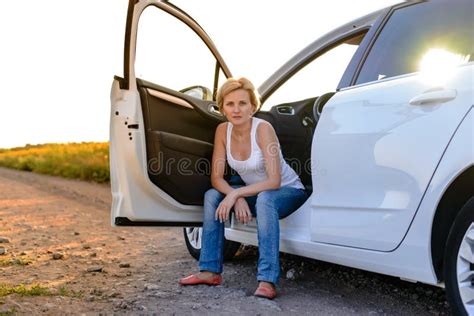 Smiling Woman Sitting In The Open Door Of Her Car Stock Image Image
