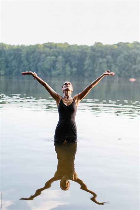 beautiful woman doing yoga in a lake by stocksy contributor jakob lagerstedt stocksy