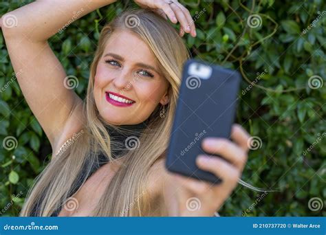 A Lovely Blonde Model Enjoys A Summers Day Outdoors At The Park Stock Photo Image Of Emotion