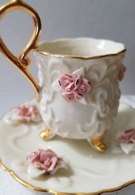Ivory Porcelain Tea Cup And Saucer With Applied Pink Rose Clusters And