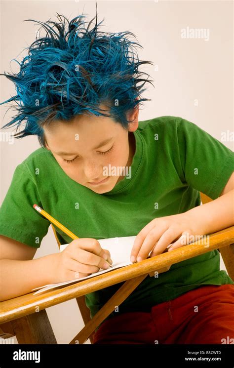 Boy With Blue Spiked Hair Writing Stock Photo Alamy