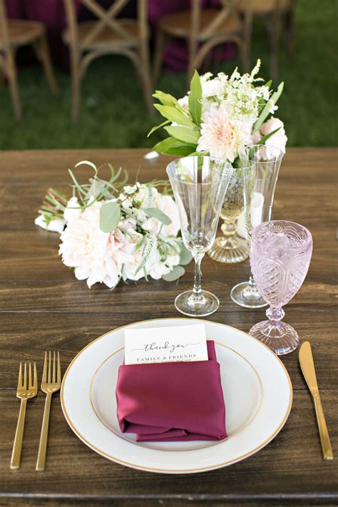 Setting a table with napkins, plates, silverware, and glasses is not as difficult as it seems. Outdoor California wedding reception place setting, maroon ...