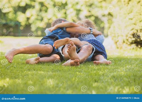 Playful Siblings Having Fun On A Green Lawn Stock Image Image Of