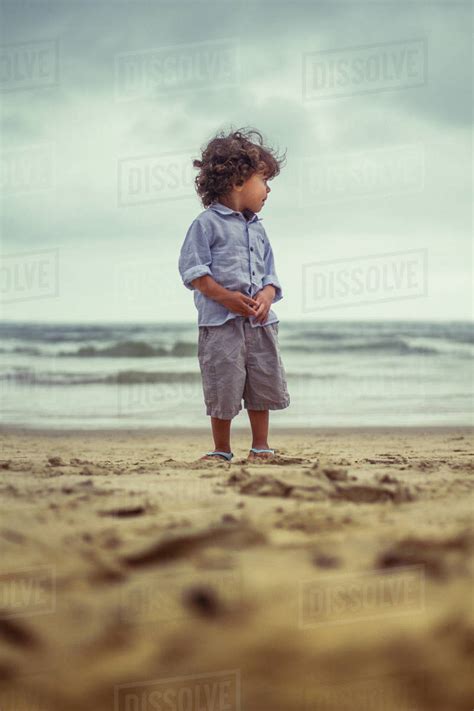Boy Standing On The Beach Stock Photo Dissolve