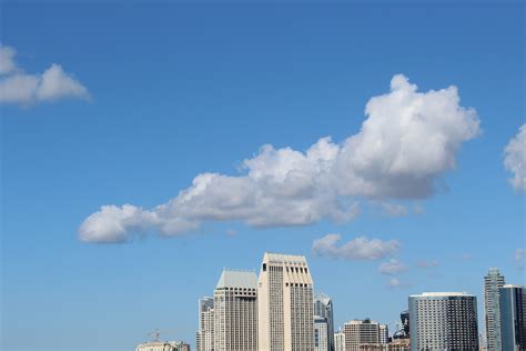 Cumulus Clouds Above High Rise Building · Free Stock Photo