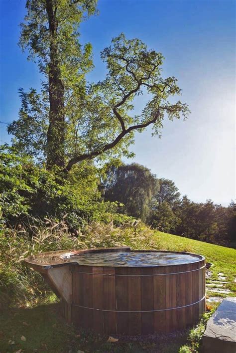 A Hot Tub In The Middle Of A Grassy Field