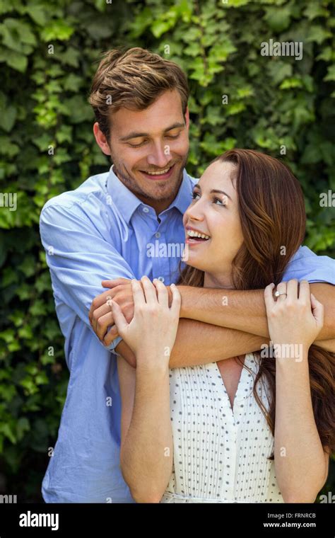 Front View Of Couple Hugging At Front Yard Stock Photo Alamy