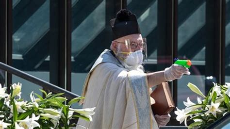 Priest Uses Squirt Gun To Shoot Holy Water So He Can Bless People At