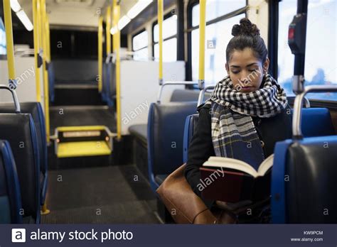 Woman Commuter Reading Book On Bus Stock Photo Alamy