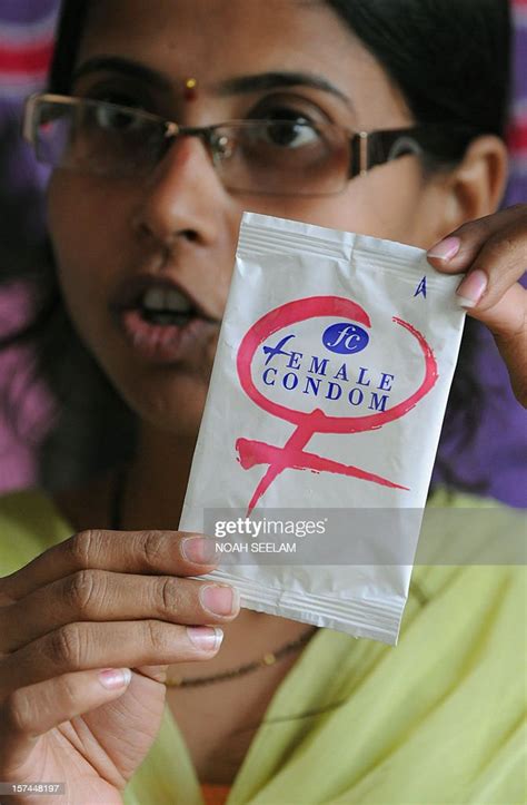 Indian Programme Officer G Shilpa Poses With A Female Condom At An