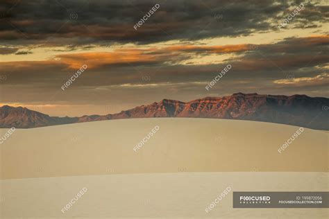 Dramatic Sunset Sky Over Sand Dunes And Mountains White Sands New