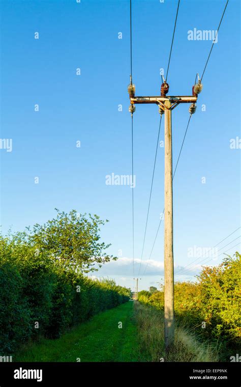 Wooden Utility Pole And Electricity Power Lines In The Countryside