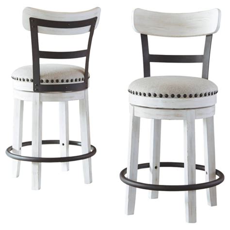 Two White And Black Barstools With One Sitting On Top Of The Other In