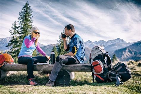 Couple Hike And Drink In Mountains — Stock Photo © Blasbike 58242665