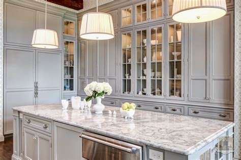 Whether you opt for oak, maple, or walnut, you can leave your hardwood floors au naturel in a kitchen with gray cabinets. Traditional Kitchen in Soft Gray - Interiors By Color