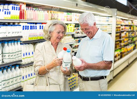 Senior Couple Buying Milk Stock Photo Image 65300983
