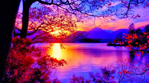 Sunset Between Snow Covered Mountains With Reflection On Calm Body Of Water Under Purple Sky Hd