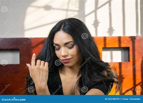 Portrait Of Sensual Latin Woman Smiling Stroking Her Beautiful Hair