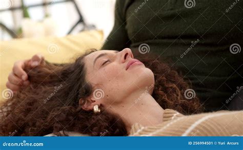 A Man And Woman Couple With Her Head On His Lap Relaxing And Stroking Her Hair Loving Calm