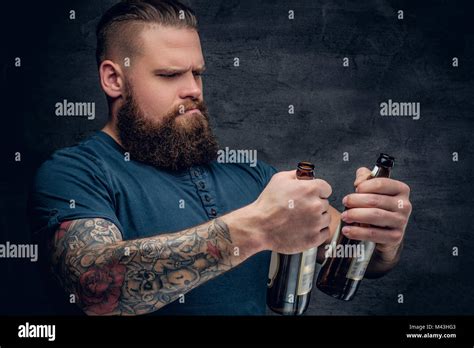 Bearded Male Looking At Two Empty Beer Bottles Stock Photo Alamy