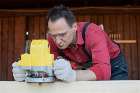 Premium Photo Craftsman Carpenter Works On Wooden Workpiece With