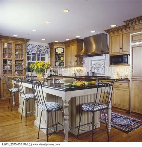 Styles change, and wood cabinetry that once looked fashionable with a stained and varnished mahogany finish may now simply look dark and dated. kitchen stained cabinets with white island | KITCHENS ...