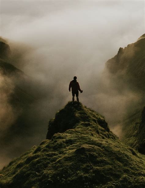 Download Premium Image Of Man Standing On A Misty Cliff Background