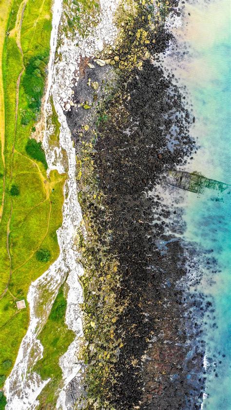 Download Wallpaper 800x1420 Coast Water Aerial View Stones Sea
