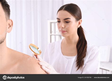 Dermatologist Examining Patient Magnifying Glass Clinic Closeup View Stock Photo By ©newafrica