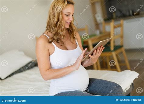 Pregnant Woman Relaxing And Using Tablet Stock Image Image Of Living Couch 133549209