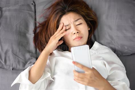 Asian Woman Rubbing Her Eyes Tired From Watching Series From Smart