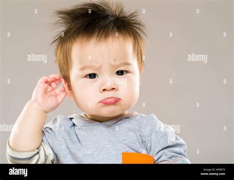 Confused Baby Boy Hand Touch Ear Stock Photo Alamy