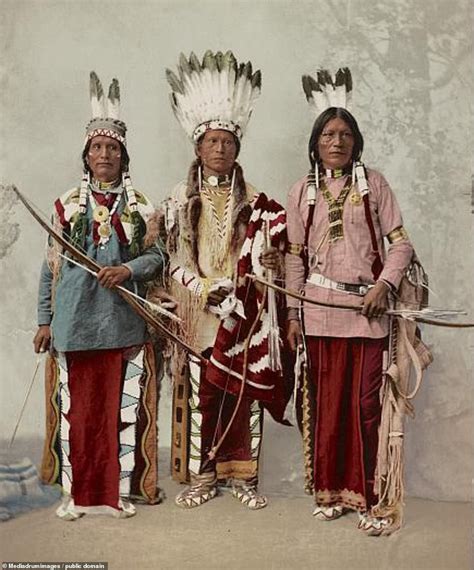 three native american indians standing next to each other