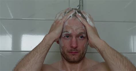 36 year old caucasian male put soap in hair and face then shower it off people stock footage